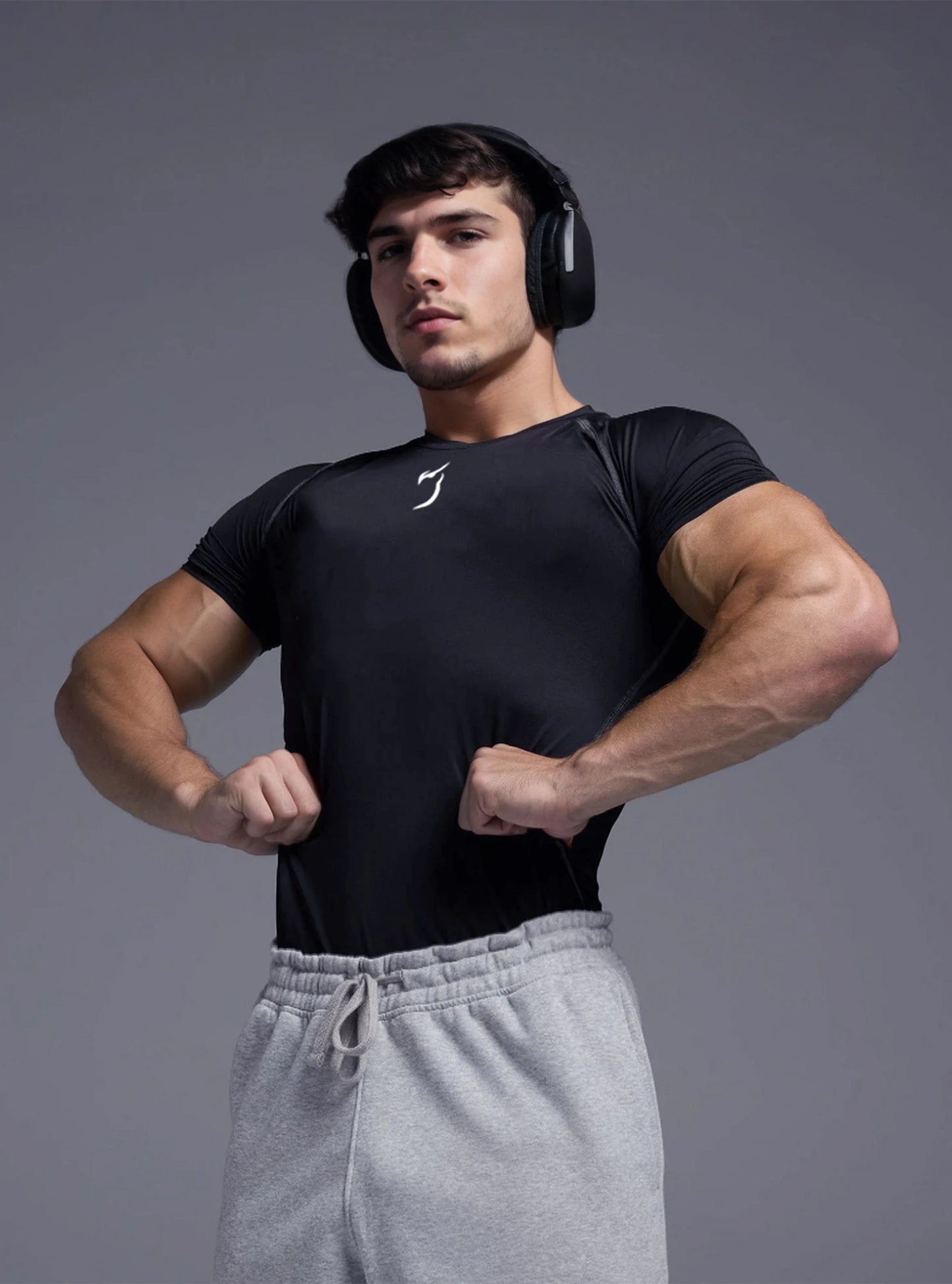 Front image of a fitness model wearing Radowl Black top gym compressor tshirt for men standing on whitedrop background