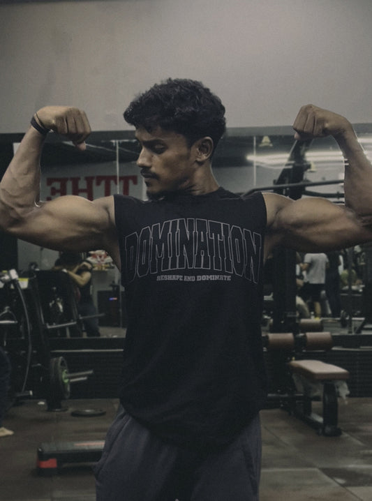 Gym athlete wearing Radowl's Domination Drive Gym Vest for men, posing in a Front Double Biceps Pose in the gym, showcasing bold 'DOMINATION' branding on the vest with a confident, muscular stance.