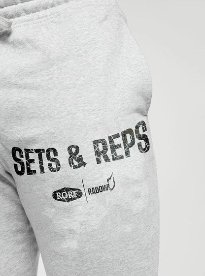 Close up of Radowl grey gym joggers for men, featuring Reps & Sets text with Radowl and RORF logos