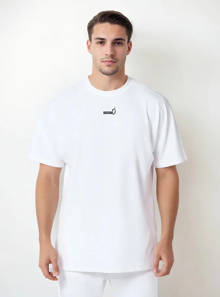 A male model wearing white Strength Heavyweight Oversized Tee White from Radowl gym wear brand this tshirt made of heavy terry which keep body warms in winters and half sleeve give you best arms mobility.