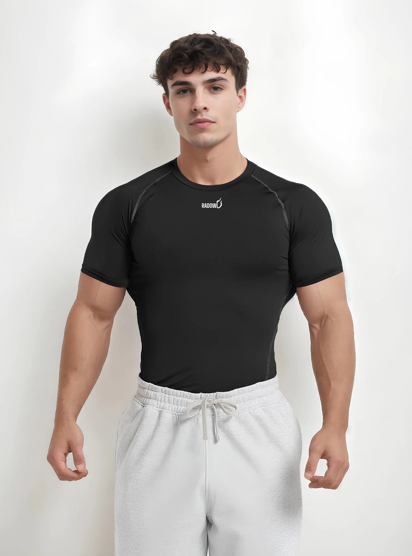 Front side photo of a gym model standing on whitedrop background wearing Radowl half sleeve gym compression t-shirt