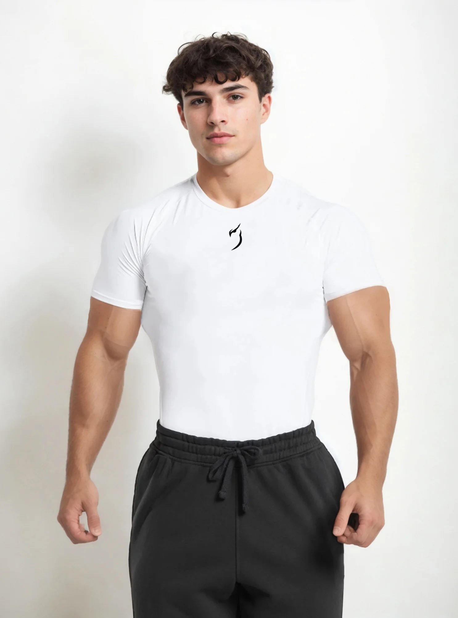 Front image of a male fitness model wearing Radowl Embelm white compression tshirt and standing on white backdrop backgound