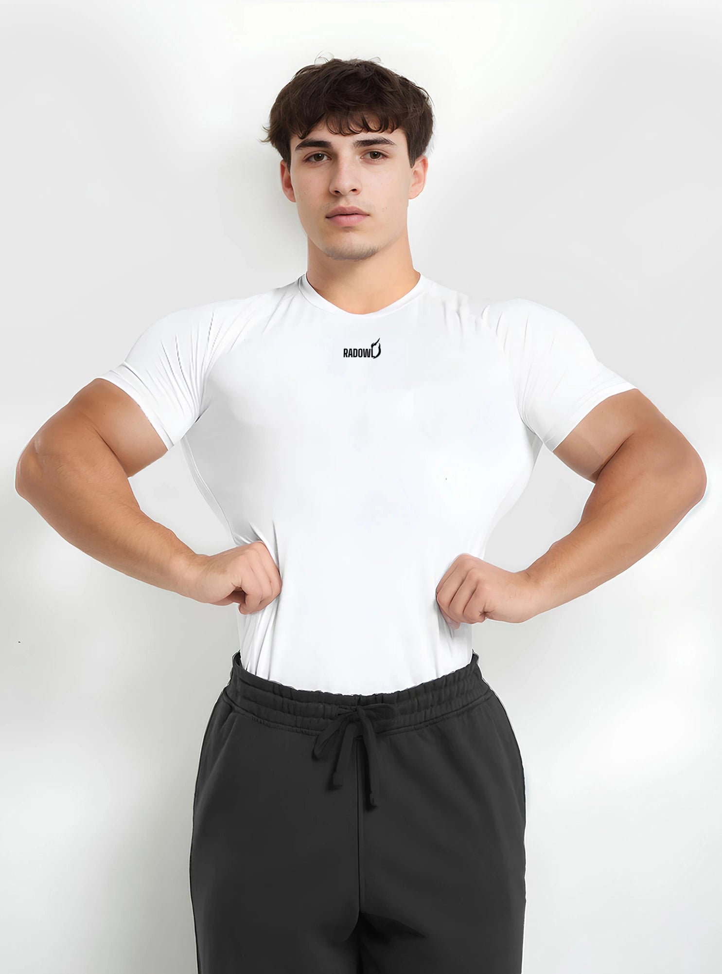 Front photo of fitness male model wearing white colour radowl half sleeve compression tshirt standing whitedrop background.