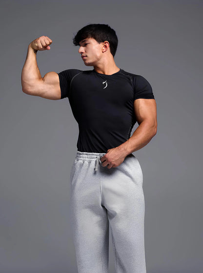 Full Front image of a fitness model wearing Radowl Black top gym compression tshirt for mens standing on whitedrop background